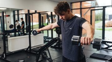 Dreng træner i fitnessrum på efterskole